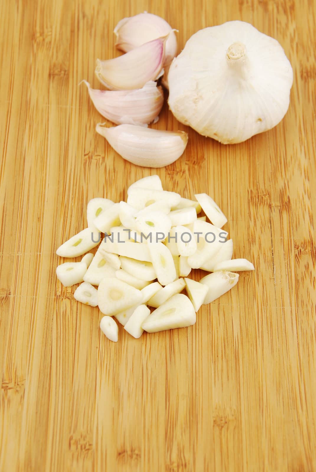 all, chopped and slices of garlic on a wooden cutting board