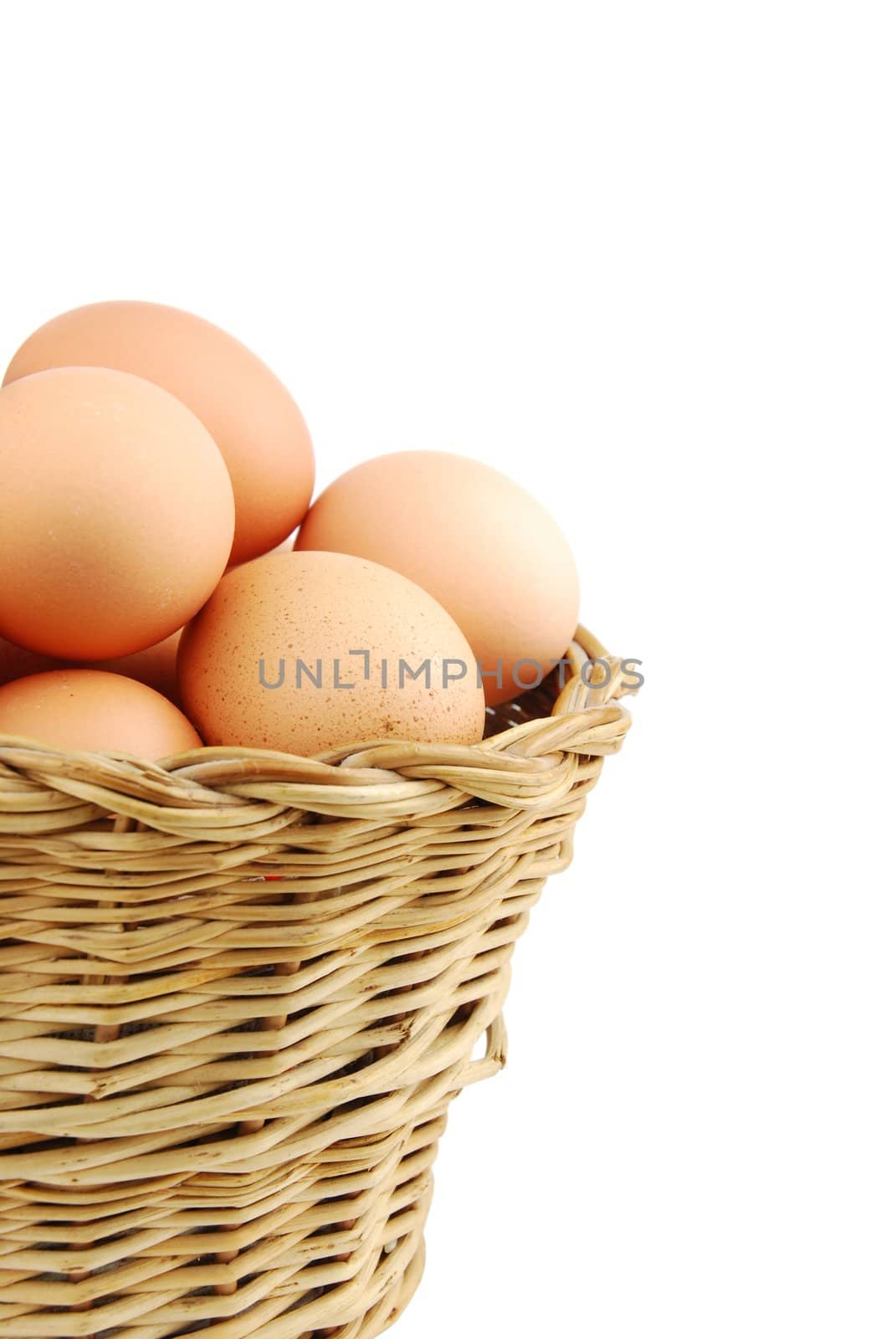 close-up of eggs in a traditional wicker basket isolated on white background