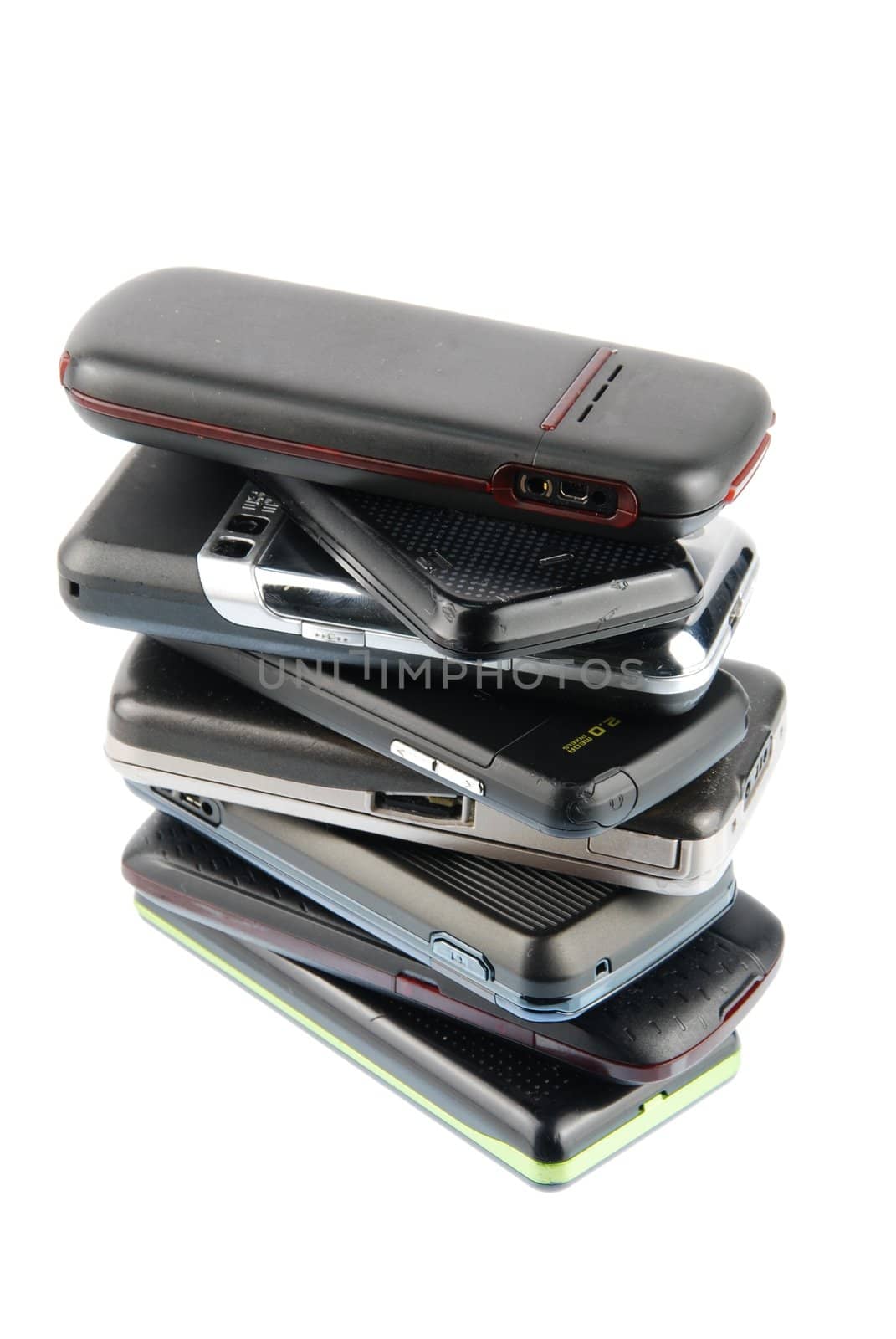 pile of several mobile phones isolated on white background