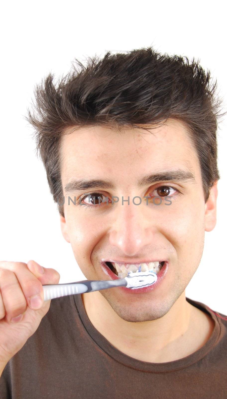 cheerful young man is washing teeth over white background
