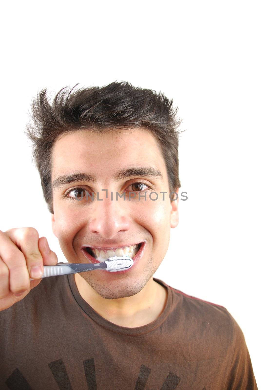 cheerful young man is washing teeth over white background
