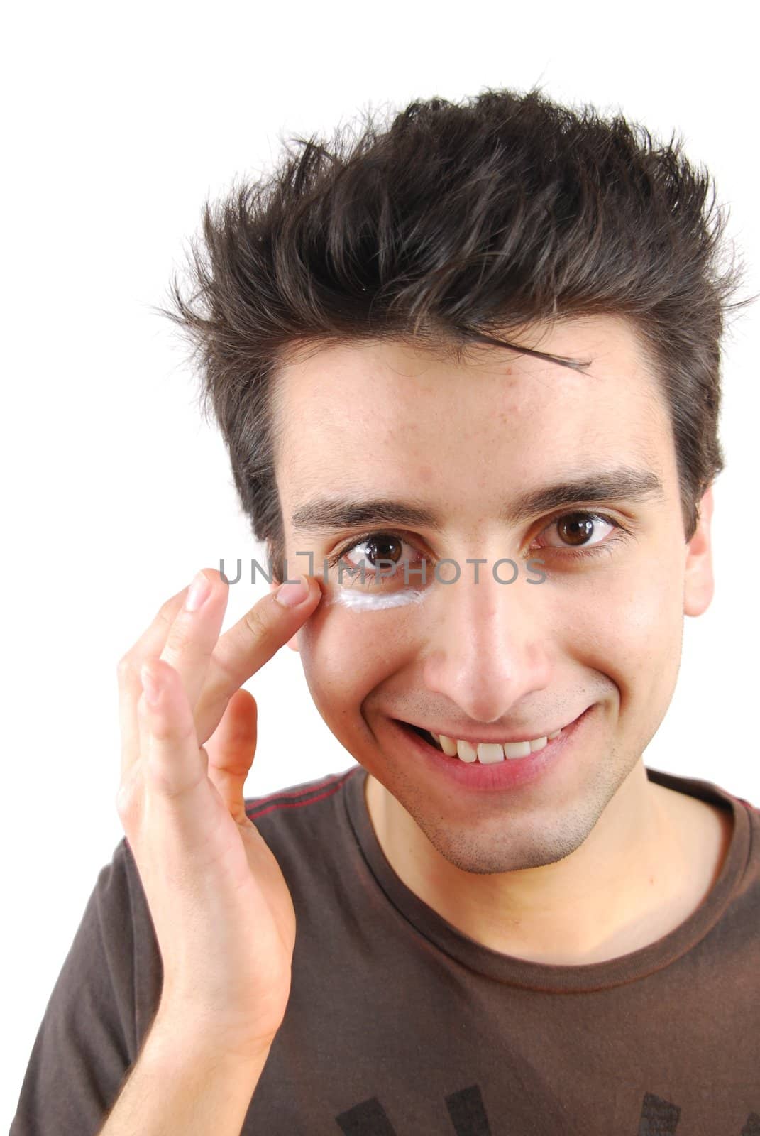 Smiling man applying eye cream by luissantos84