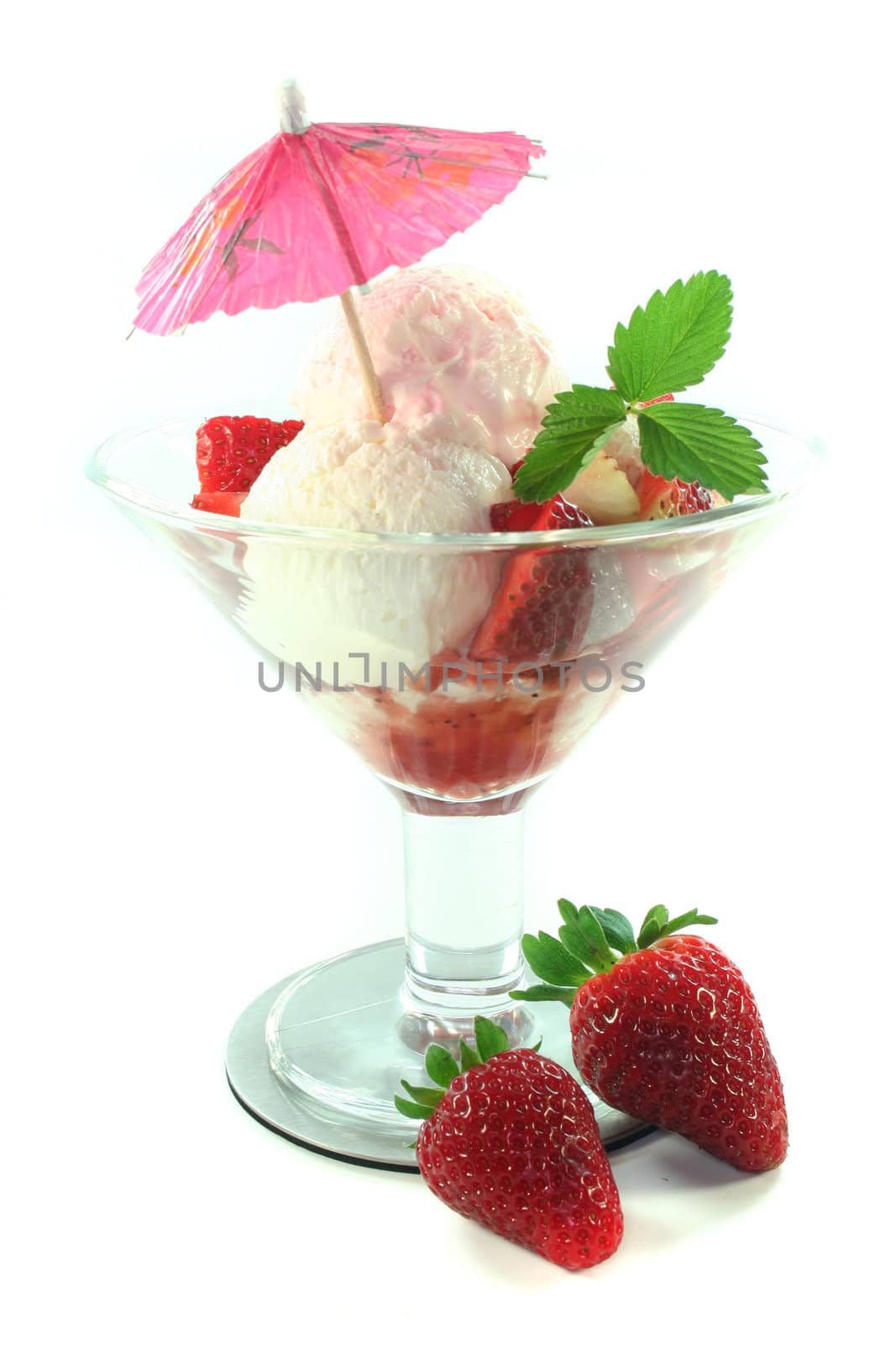 Strawberry ice cream on a silver dish and a fresh strawberry