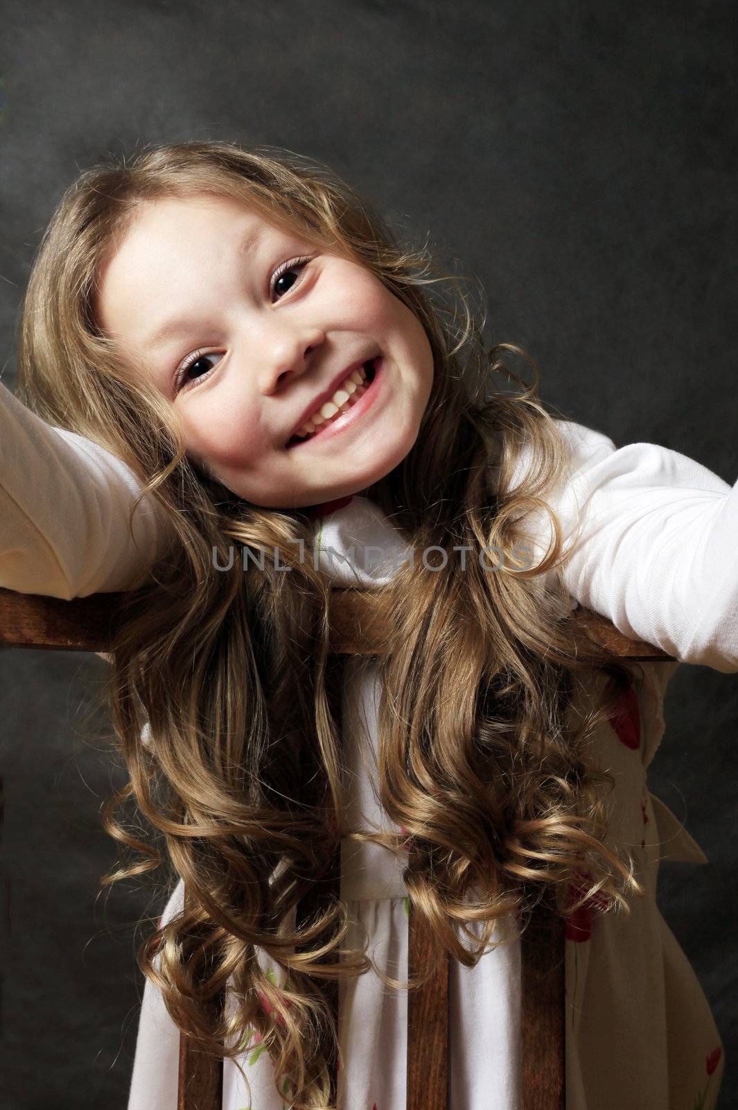 Portrait of young girl smiling on black background