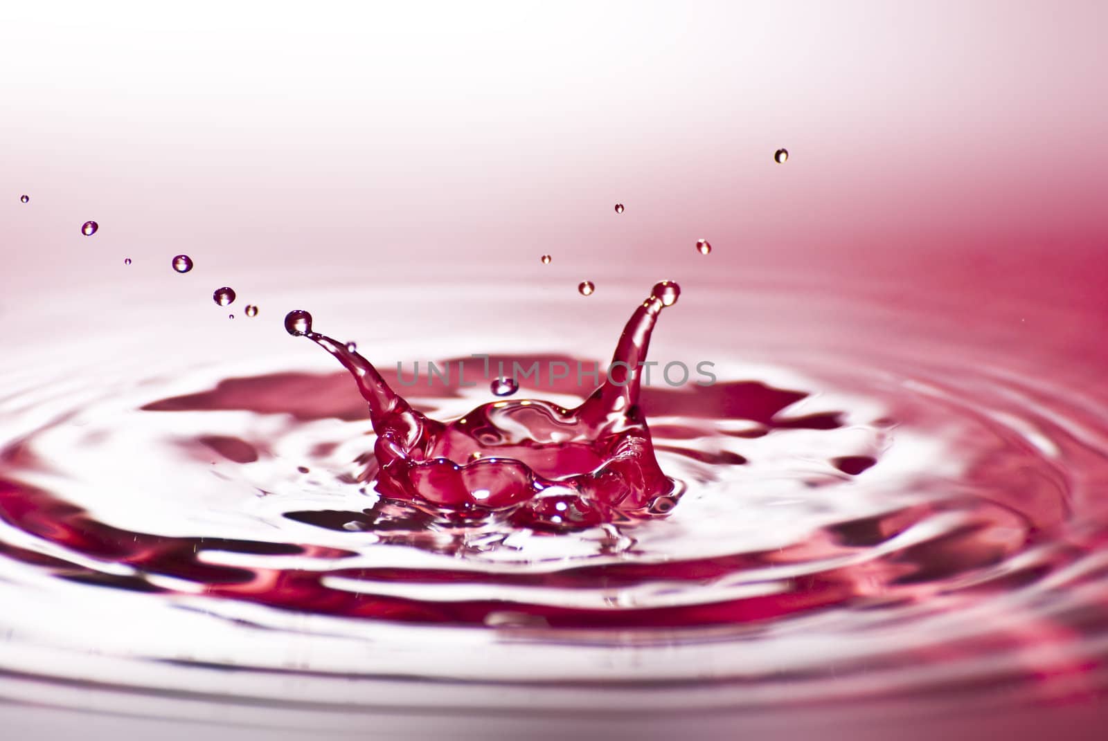 Red water environmental abstract background - red water drop splashing in clear clean water