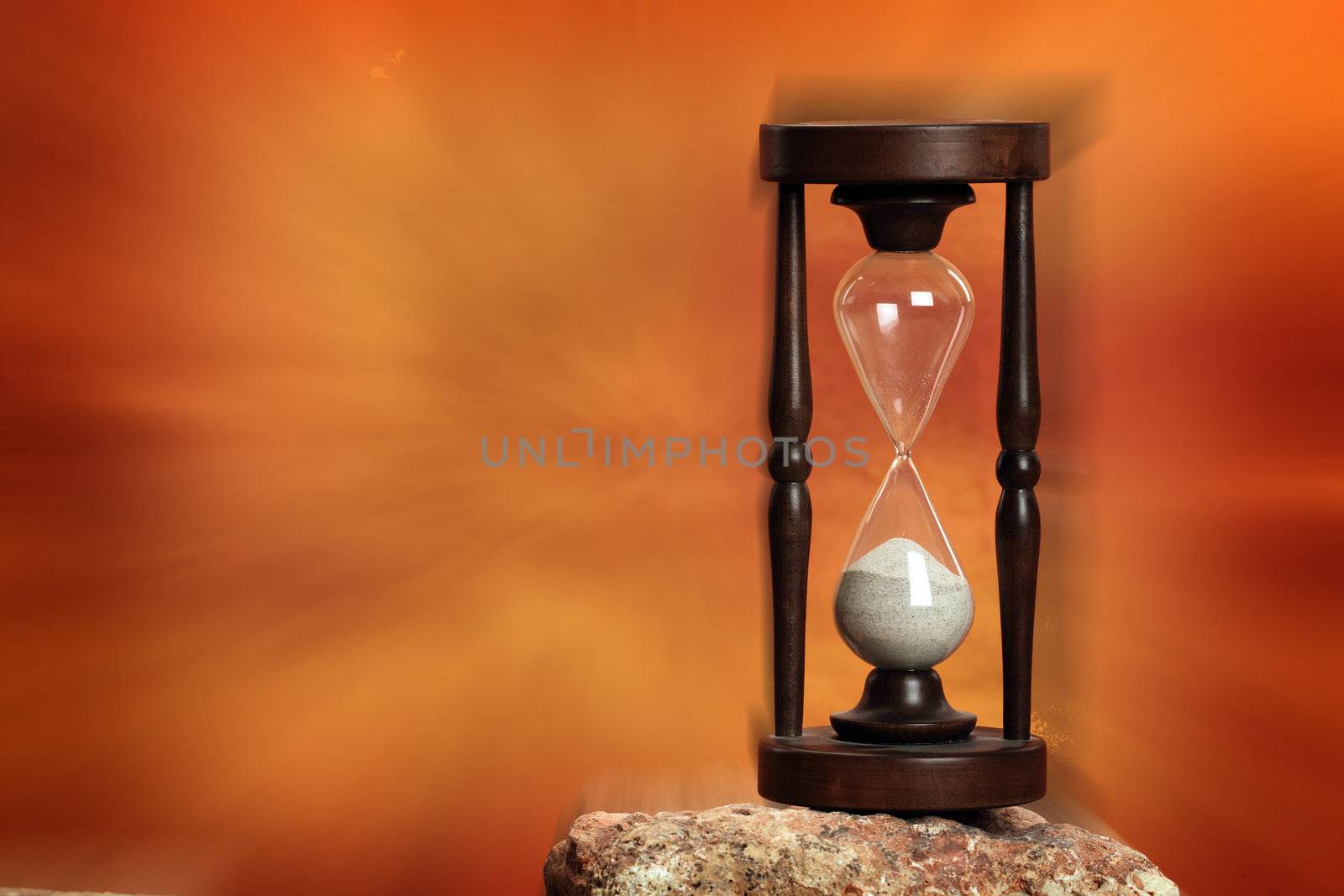 Hourglass close up over dramatic red background