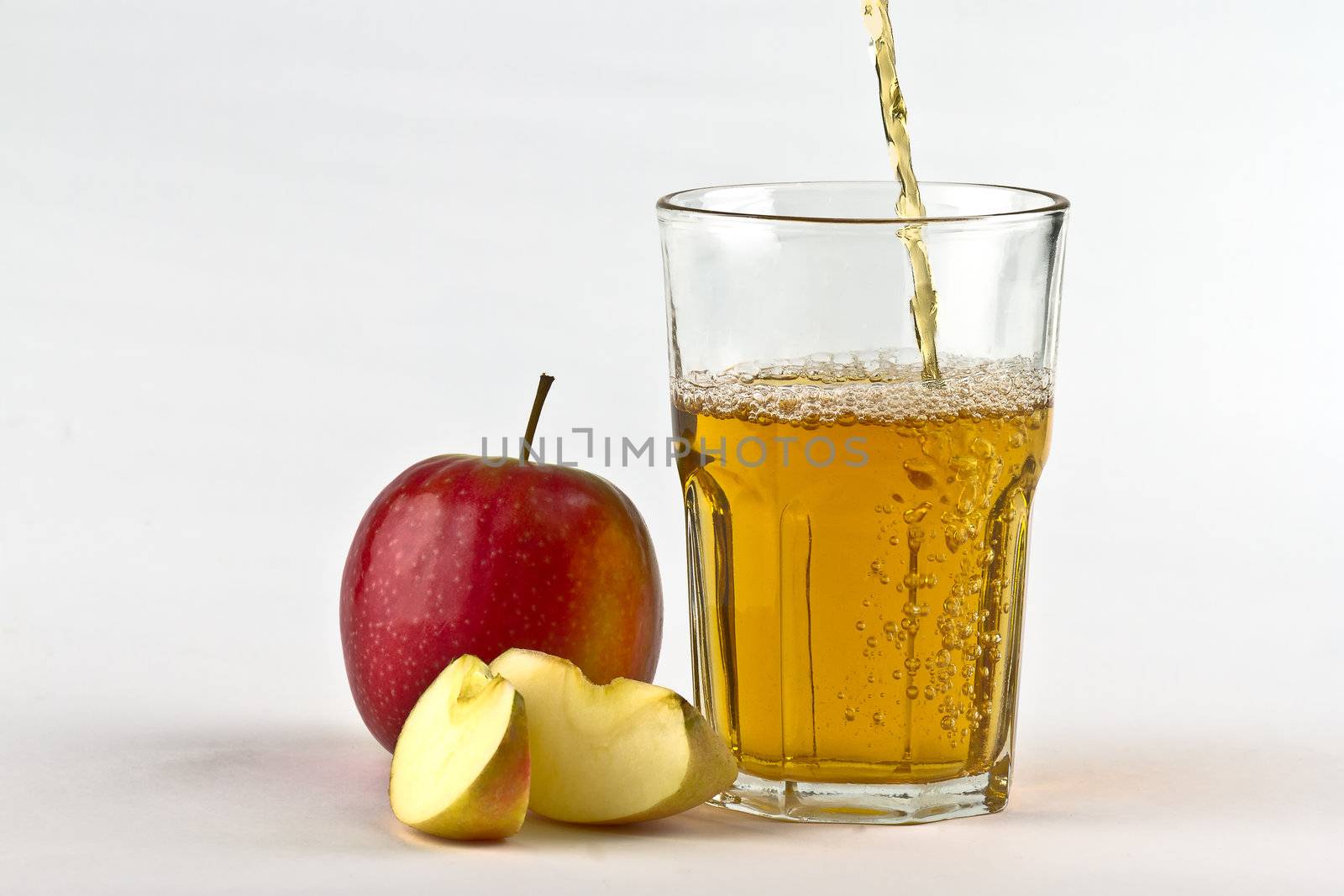 Apple cider pouring down into glass by lavsen