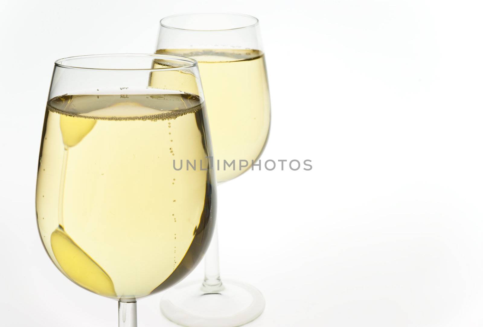 Merry Christmas and happy New year. Pair of champagne flutes making a toast, isolated on white background.