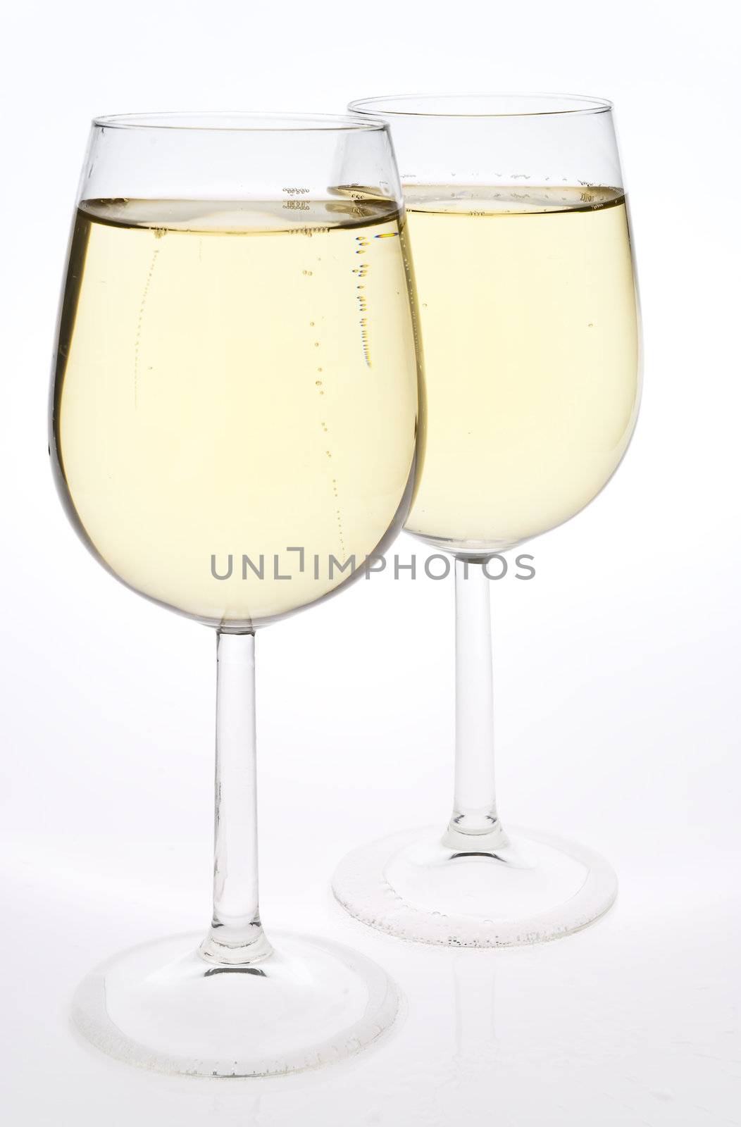 Merry Christmas and happy New year. Pair of champagne flutes making a toast, isolated on white background.