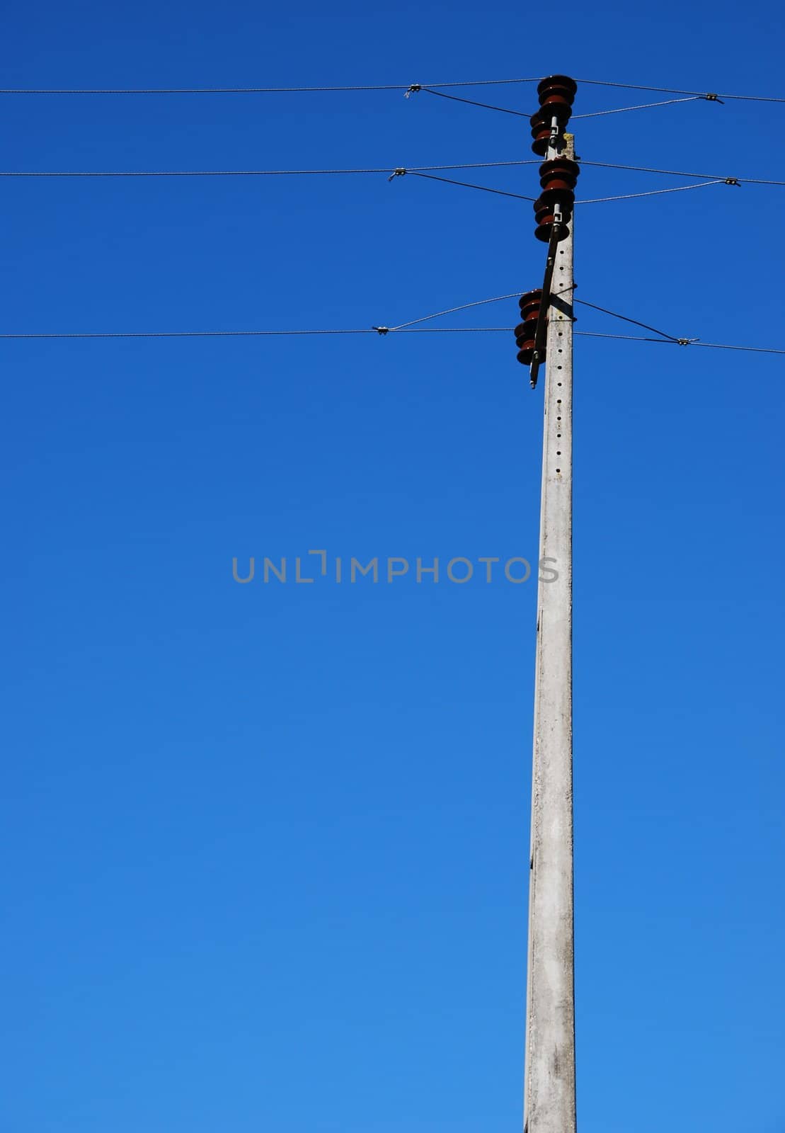 old electricity post in a small village (blue sky background)