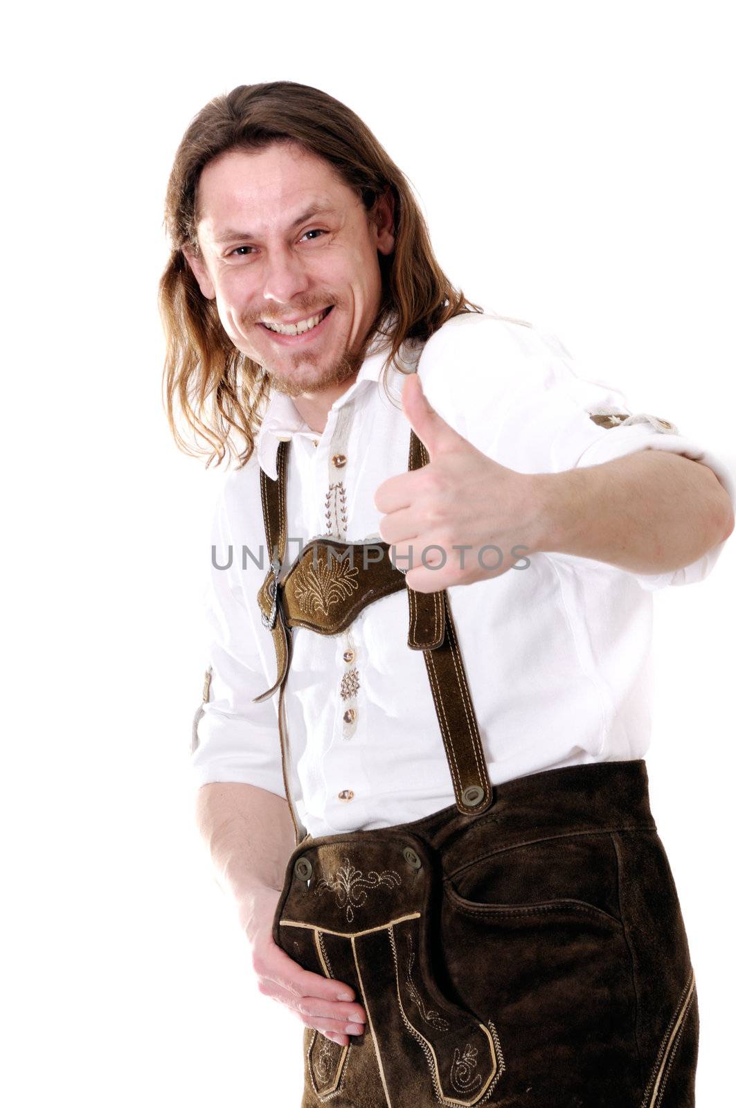 Successful young bavarian man in traditional costume at oktoberfest