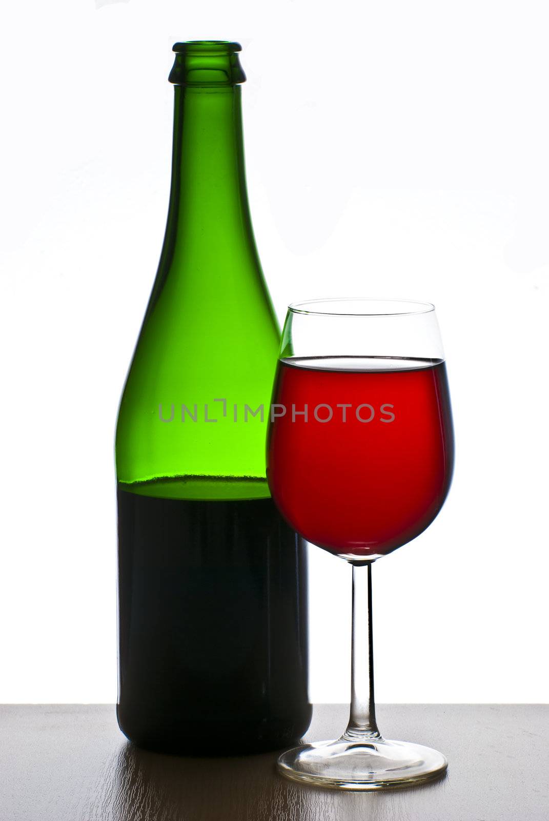 Bottle and glass of red wine isolated on white background