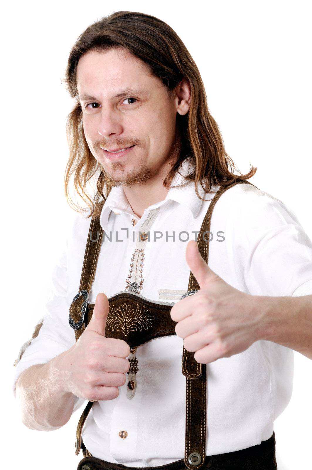 Successful young bavarian man in traditional costume at oktoberfest