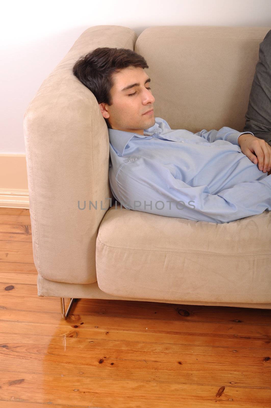 attractive young man sleeping on the couch