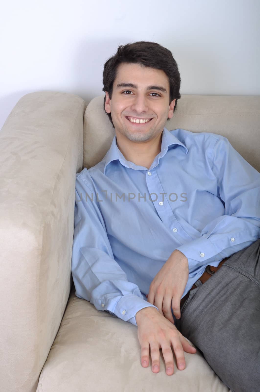 attractive young man lying and relaxing on the couch