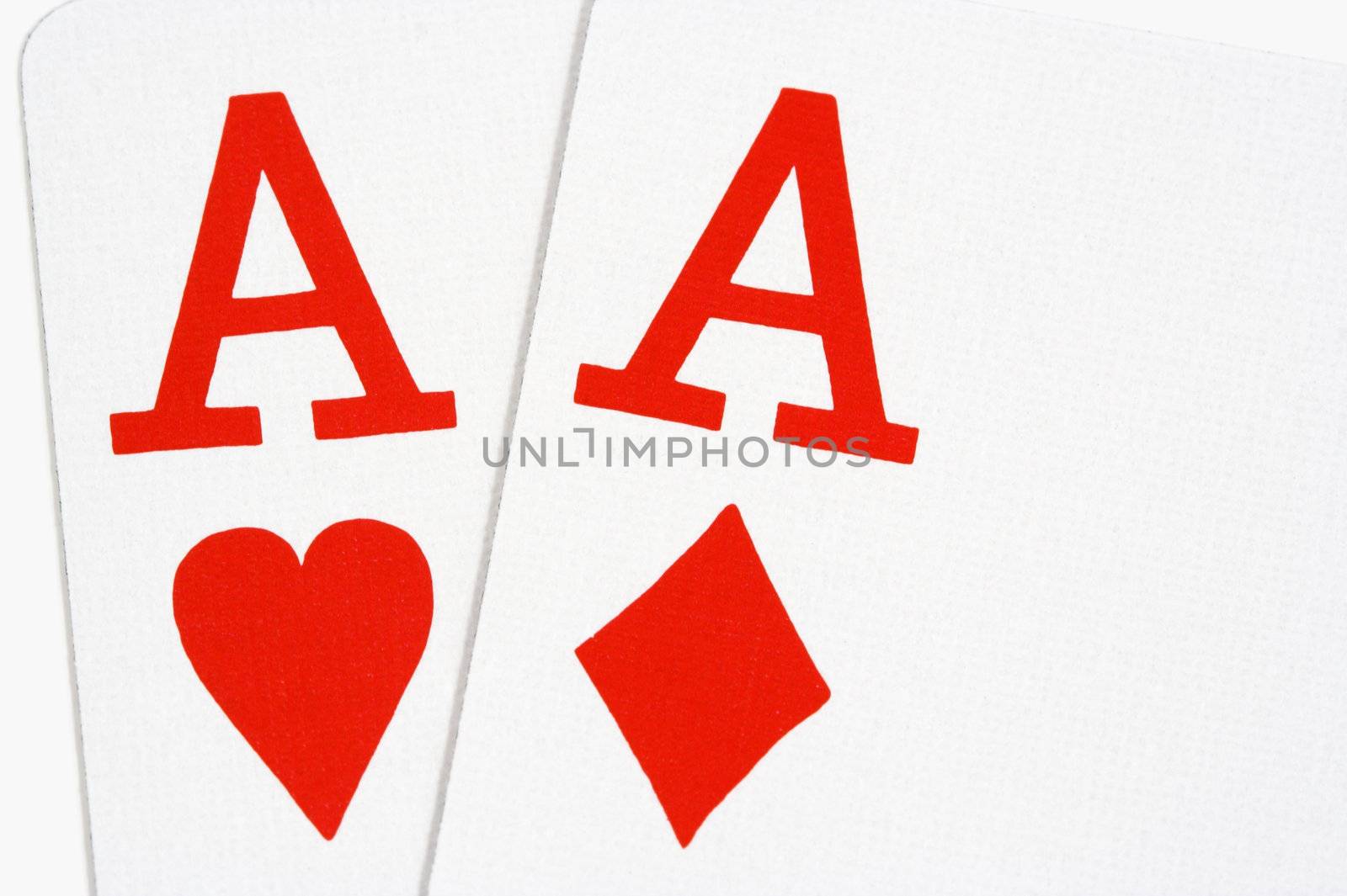 Ace of hearts and ace of diamonds on white background