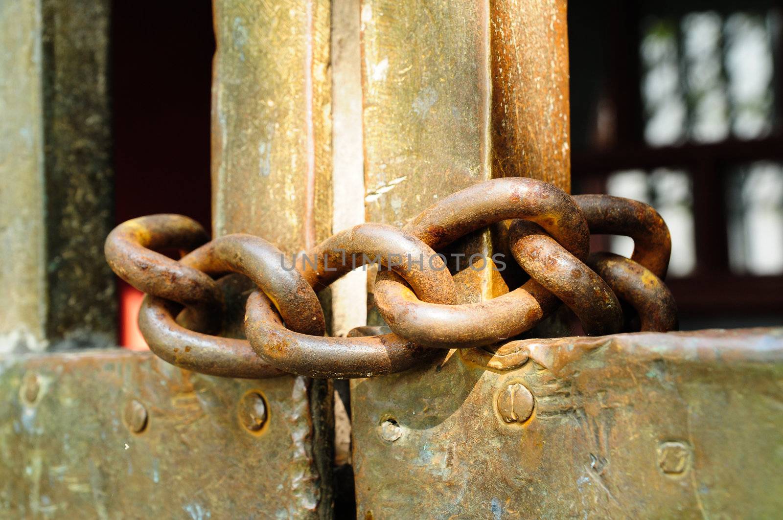 Rusty chain hanging on a door