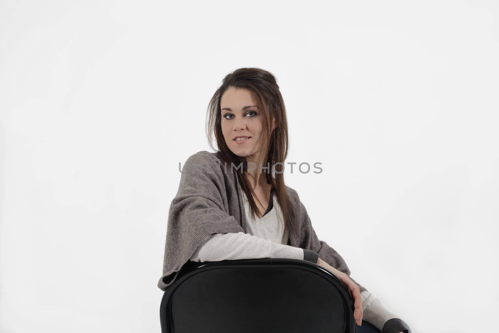 Young woman in studio with metalic chair, looking at the camera by macintox