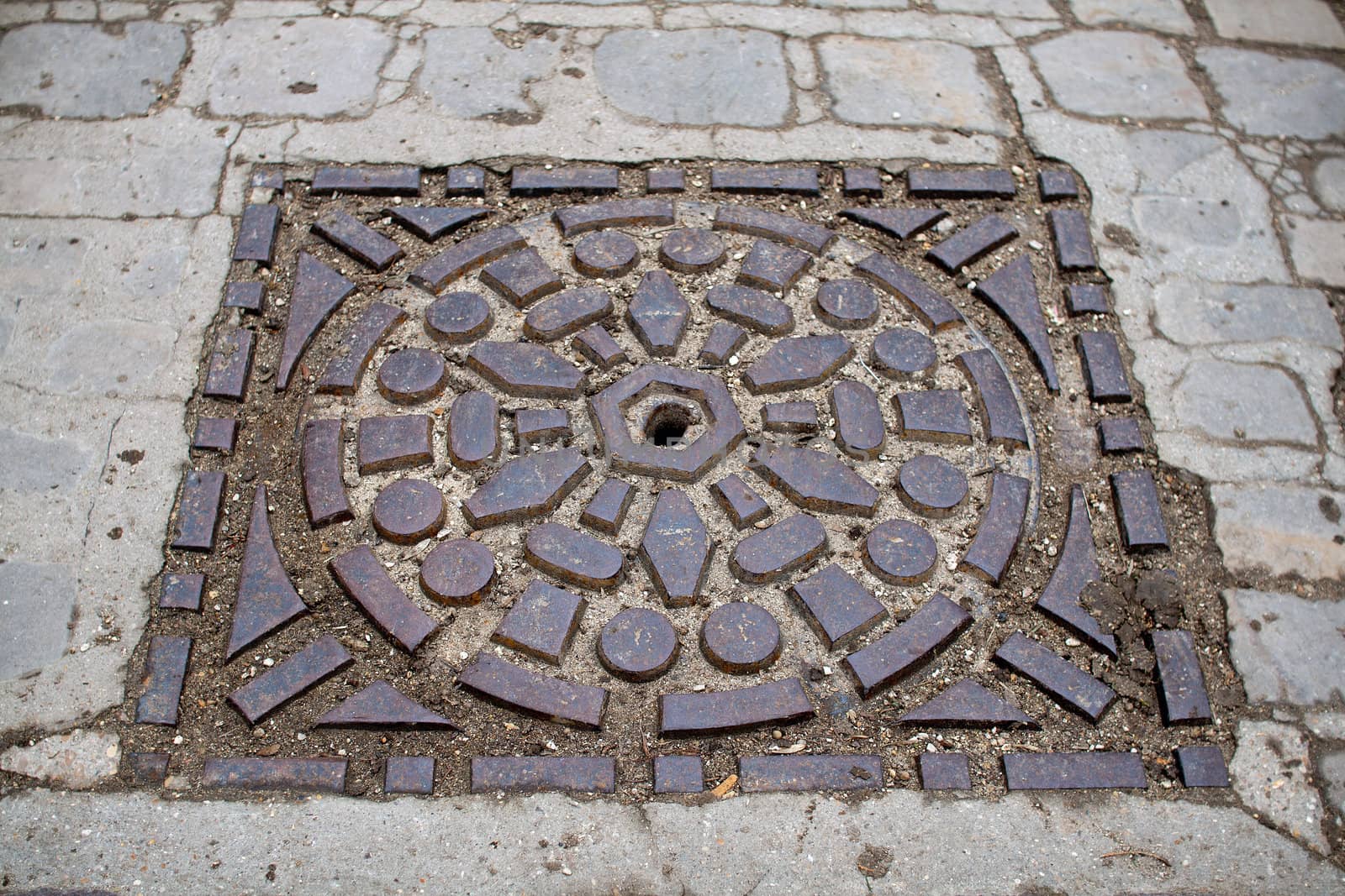 sewer's patch encircled of beautiful stones