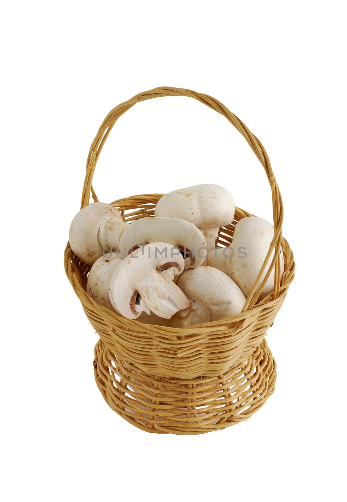 Fresh champignons in small interwoven straw basket isolated on white background