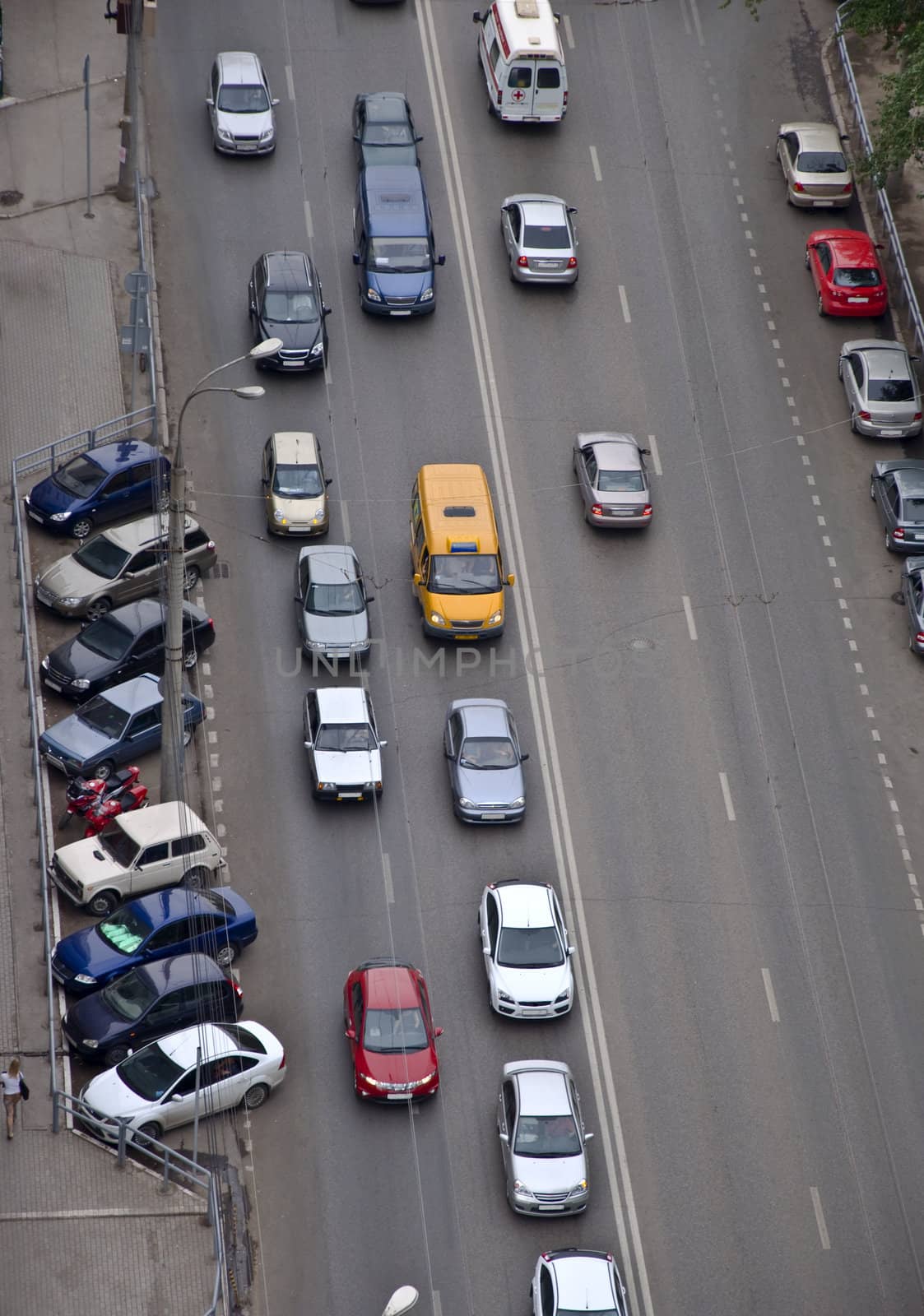 Road with car traffic. On the side of parked cars. Photo is made from a height.