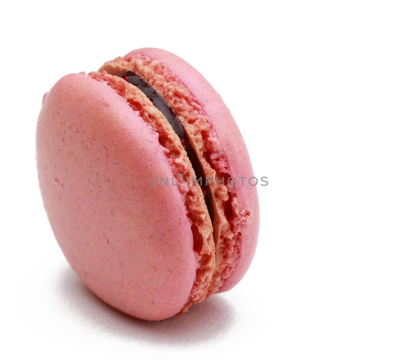 Image of a traditional French pink macaron against a white background.