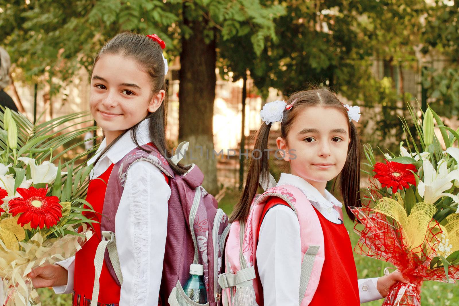 Two pretty young girls on their way to school by manaemedia