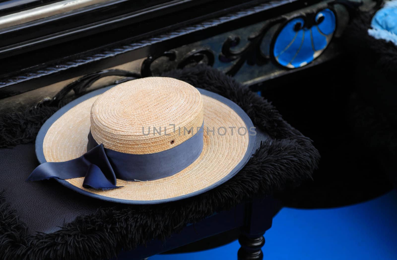 Image of a hat of a gondolier on a specific chair in a gondola.