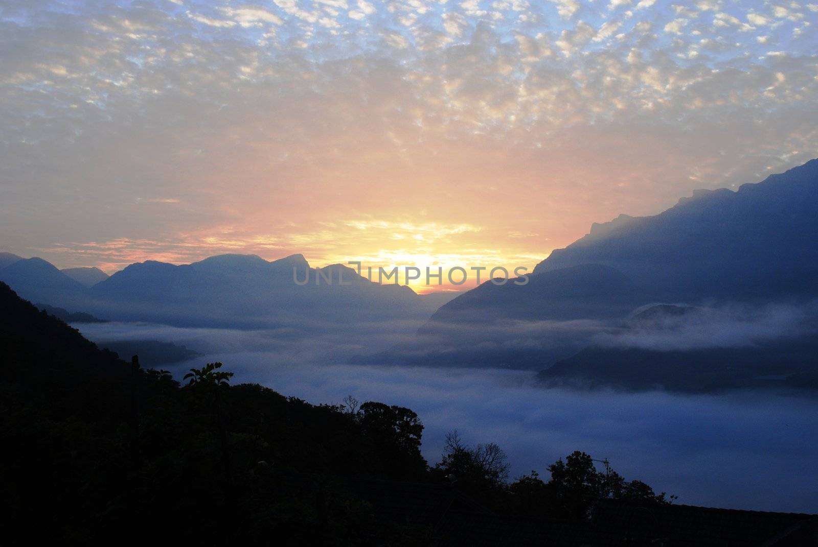 sunrise over a valsugana covered by clouds