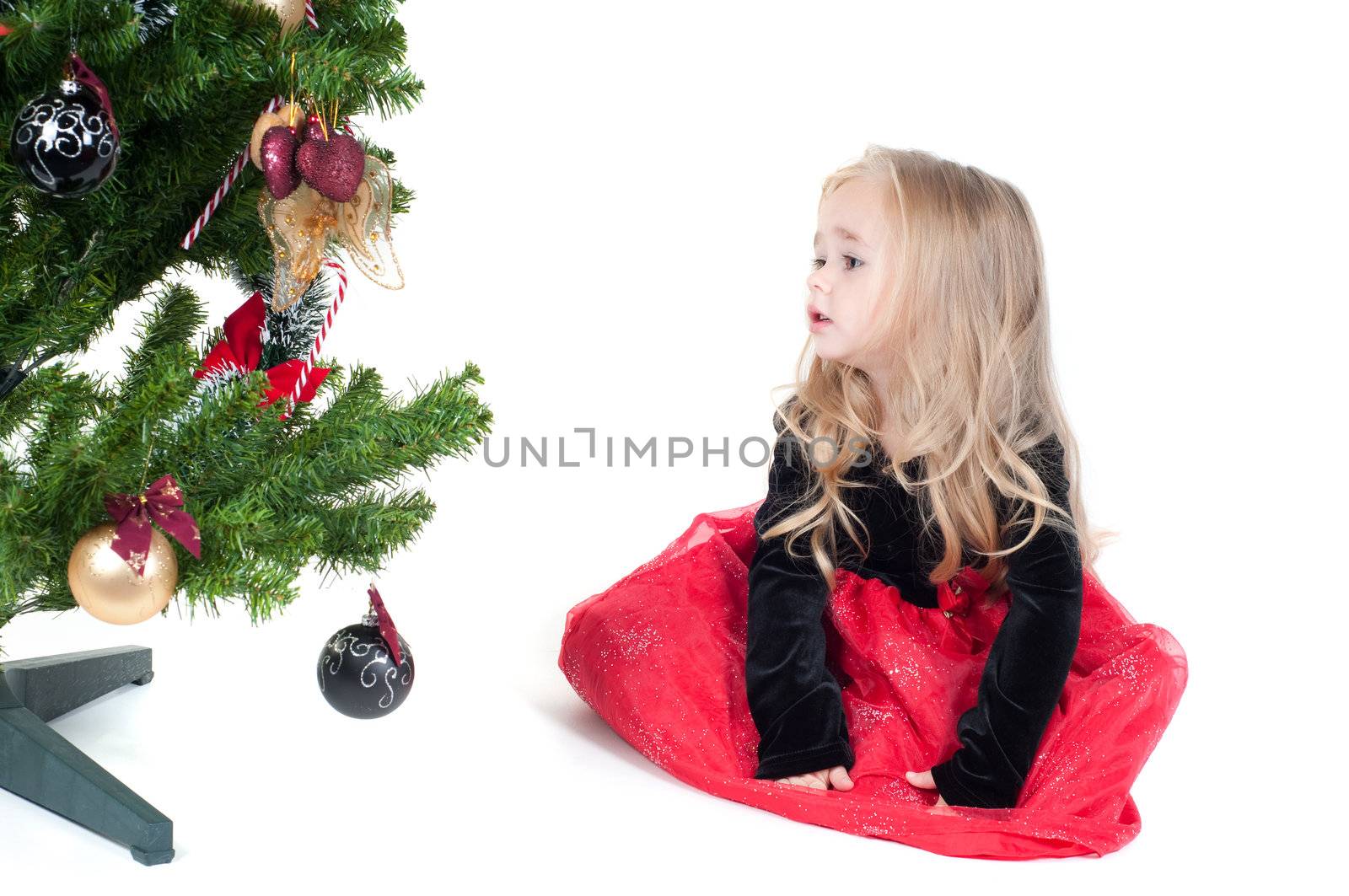 Beautiful baby girl dressed up for Christmas isolated in white