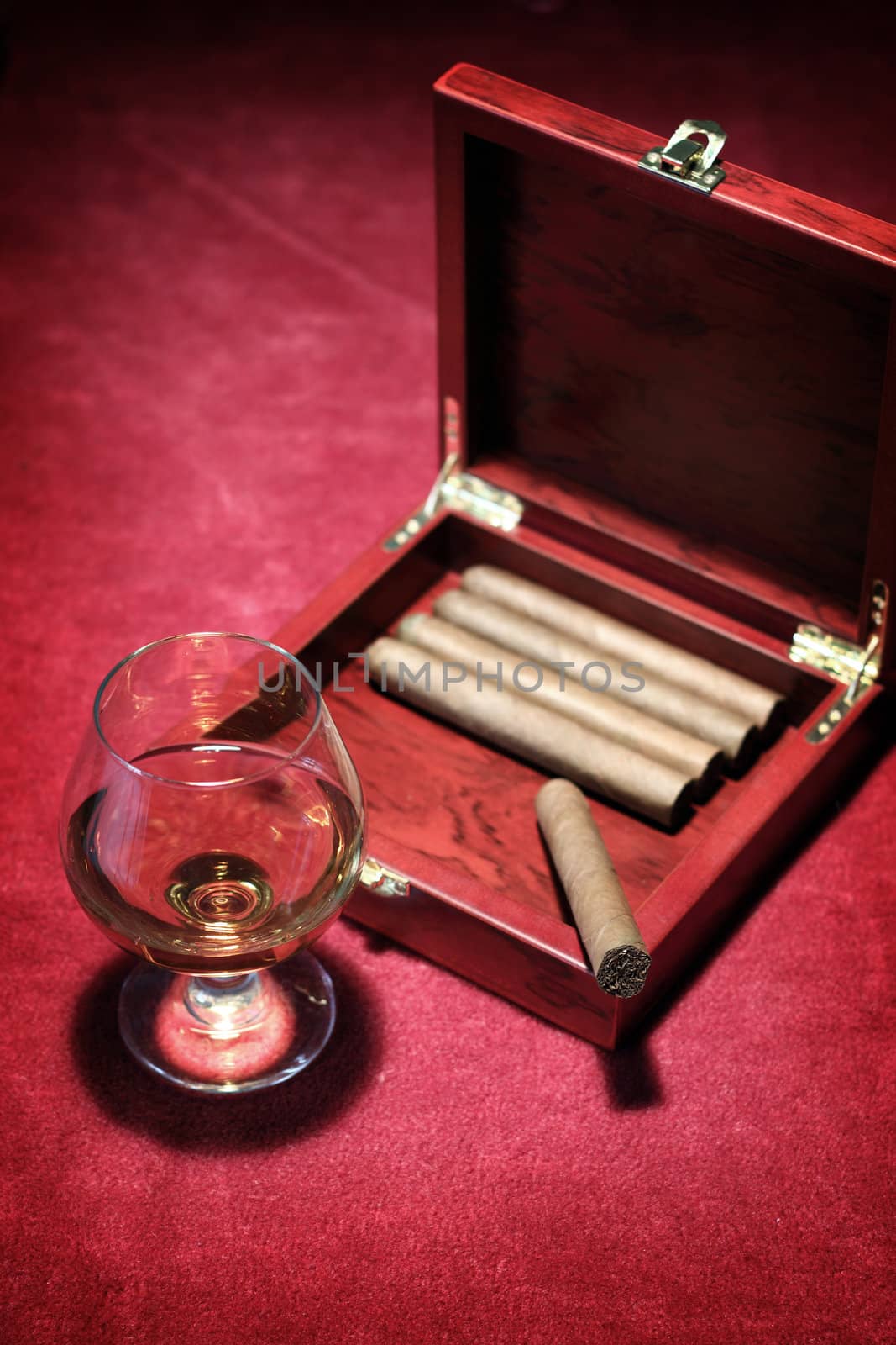 cigars in the box and glass with whisky, close up shallow dof 