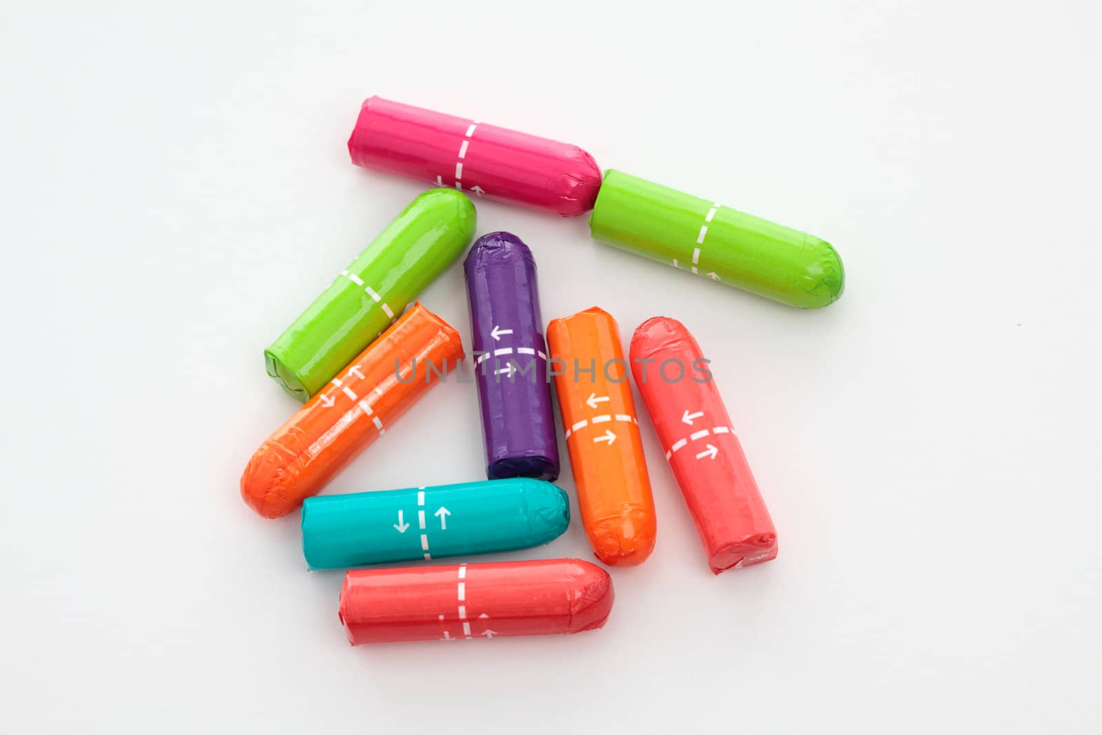 Colourful wrapped tampons on a white background.