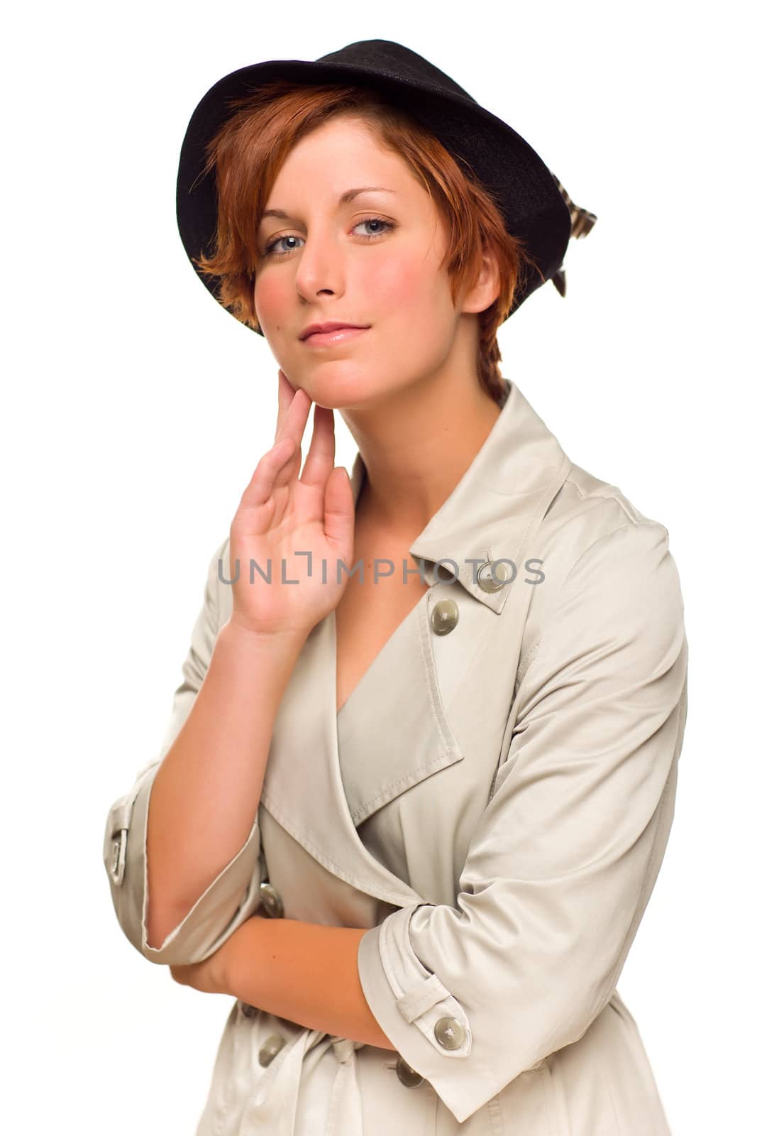 Attractive Red Haired Girl Wearing a Trenchcoat and Hat Isolated on a White Background.