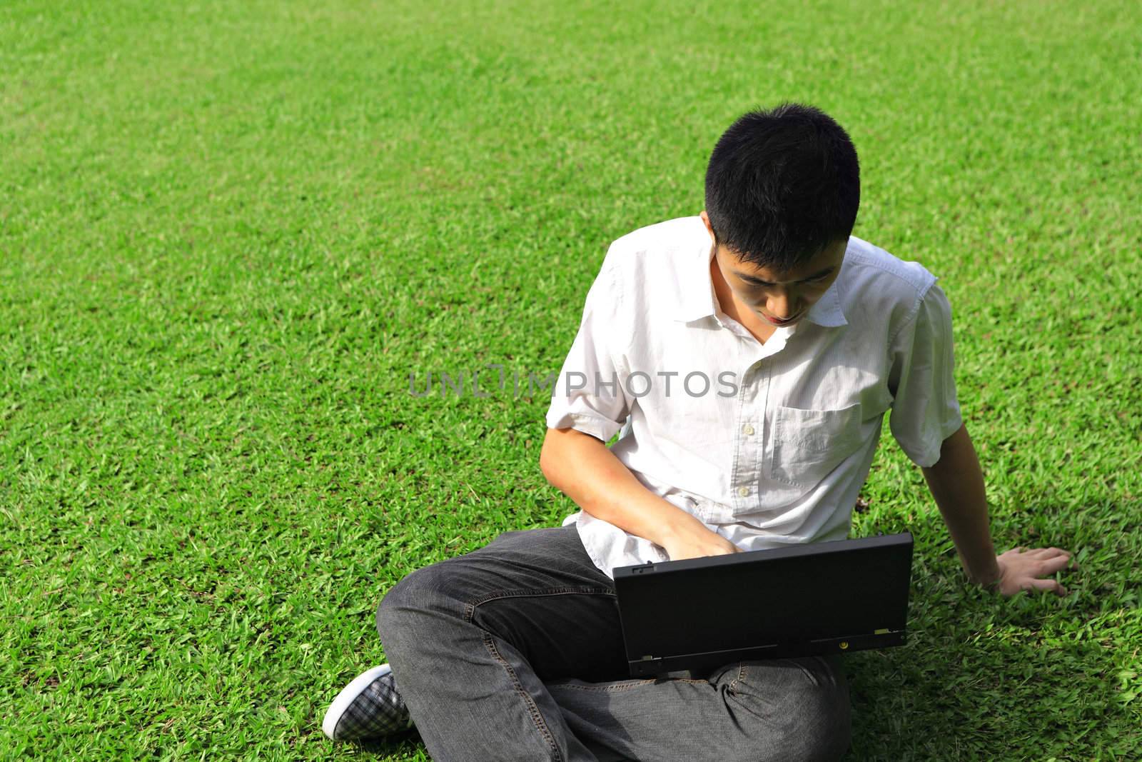 asian man using computer outdoor