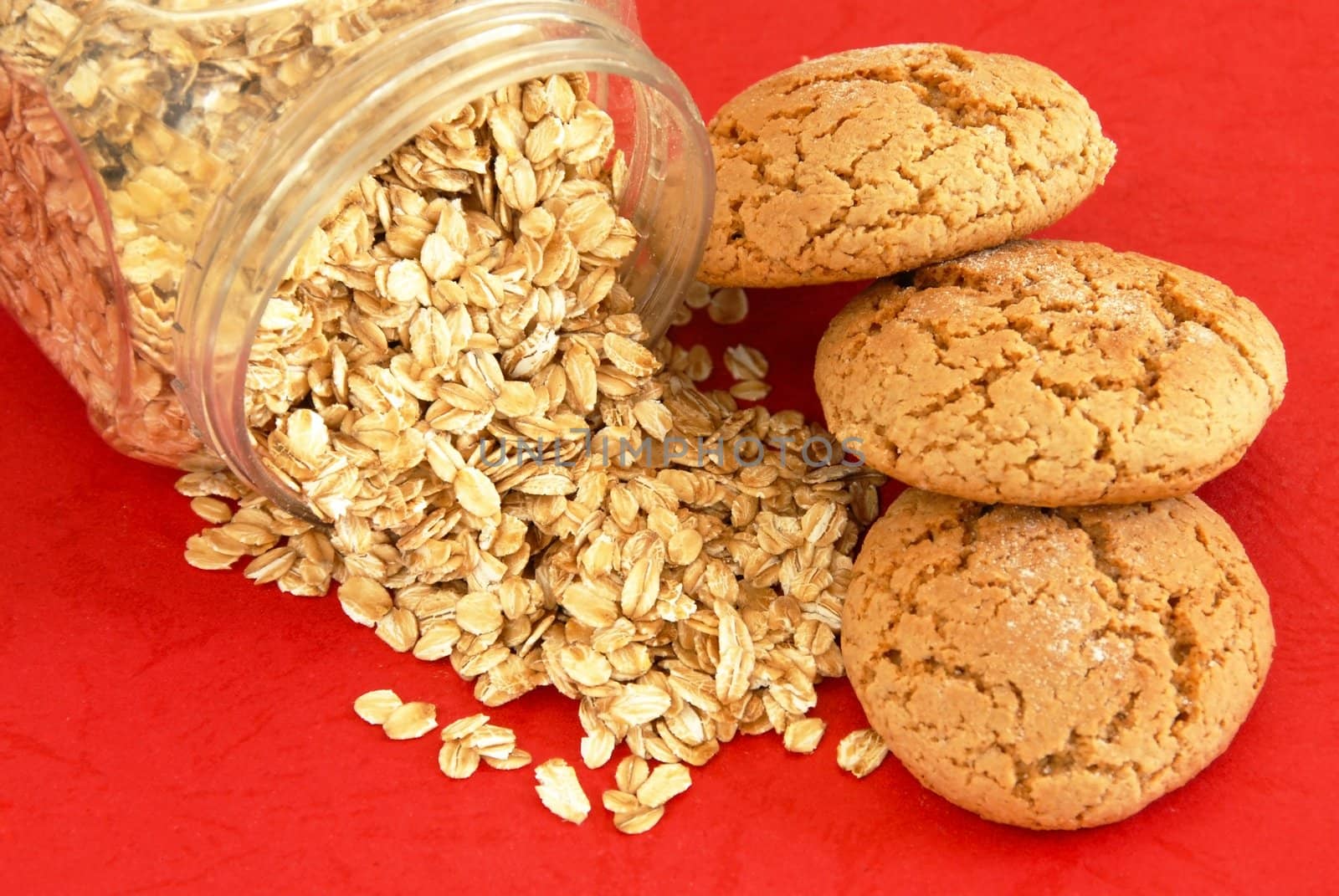 three fresh appetizing oatmeal cookies over red background