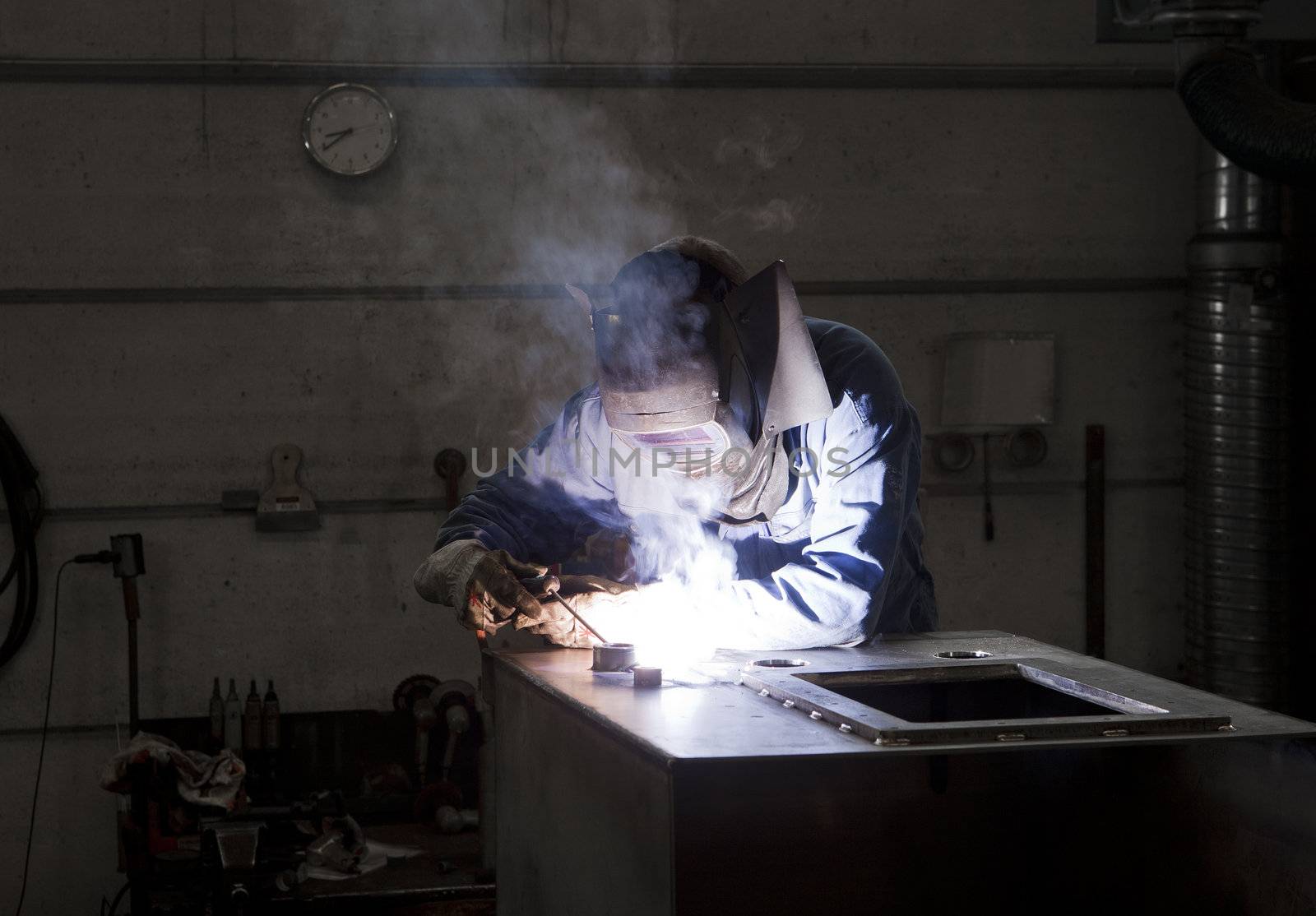 Welding operator in an auto repair shop
