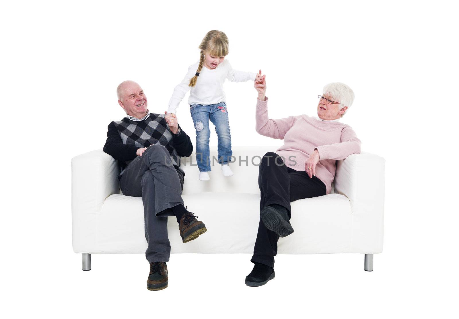 Little Girl with her grandparents in a sofa isolated on white background