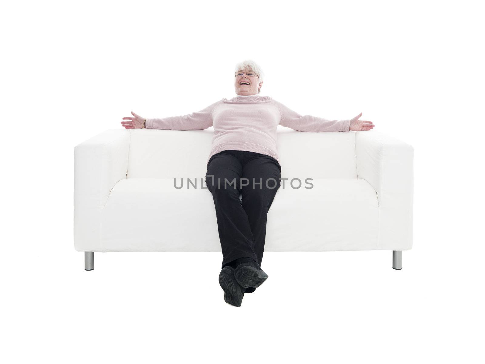 Older woman in a sofa isolated on white background