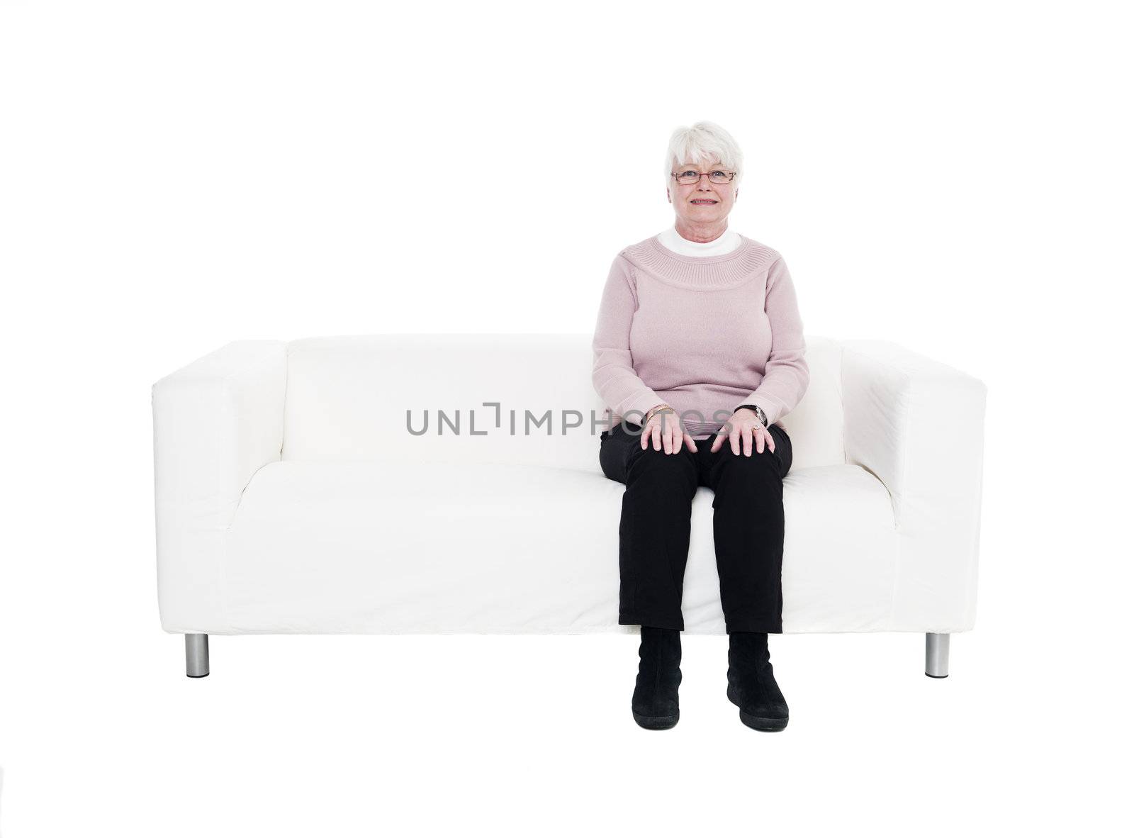 Older woman in a sofa isolated on white background