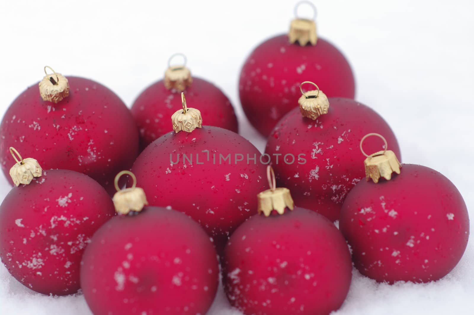 a red bauble in snowy lwinter andscape