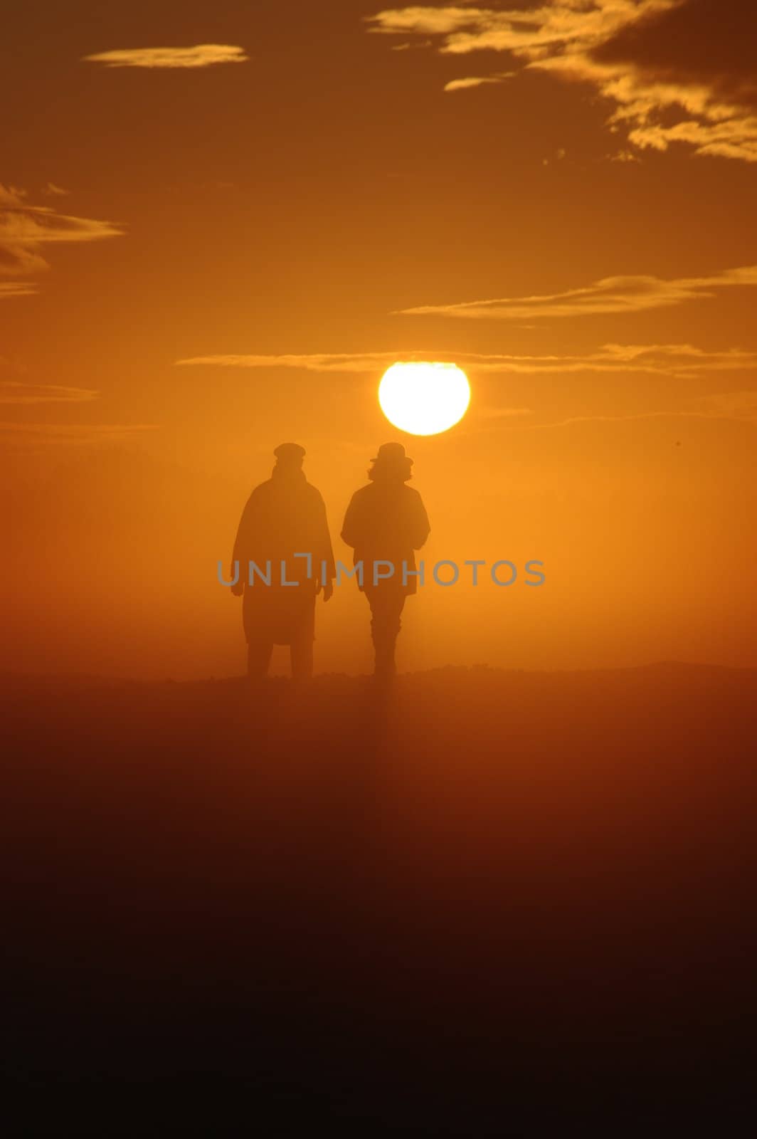 a couple have a walk through a misty landscape