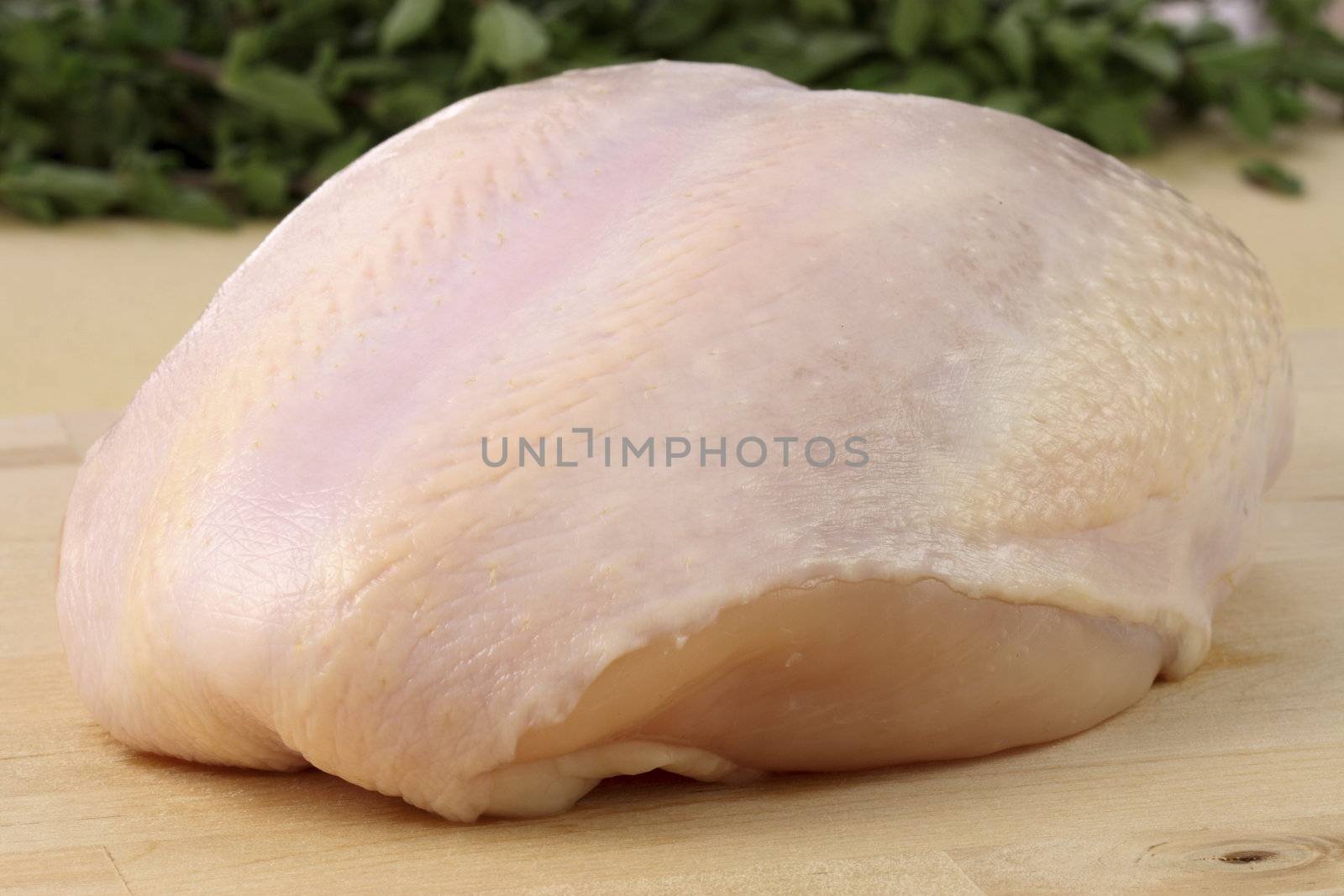 raw and juicy  turkey breast with herbs on background fresh and healthy food