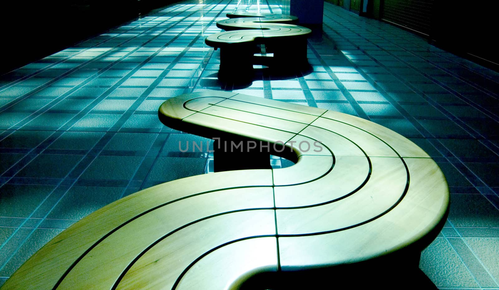 horizontal row of modern benches in blue hall interior, Japan