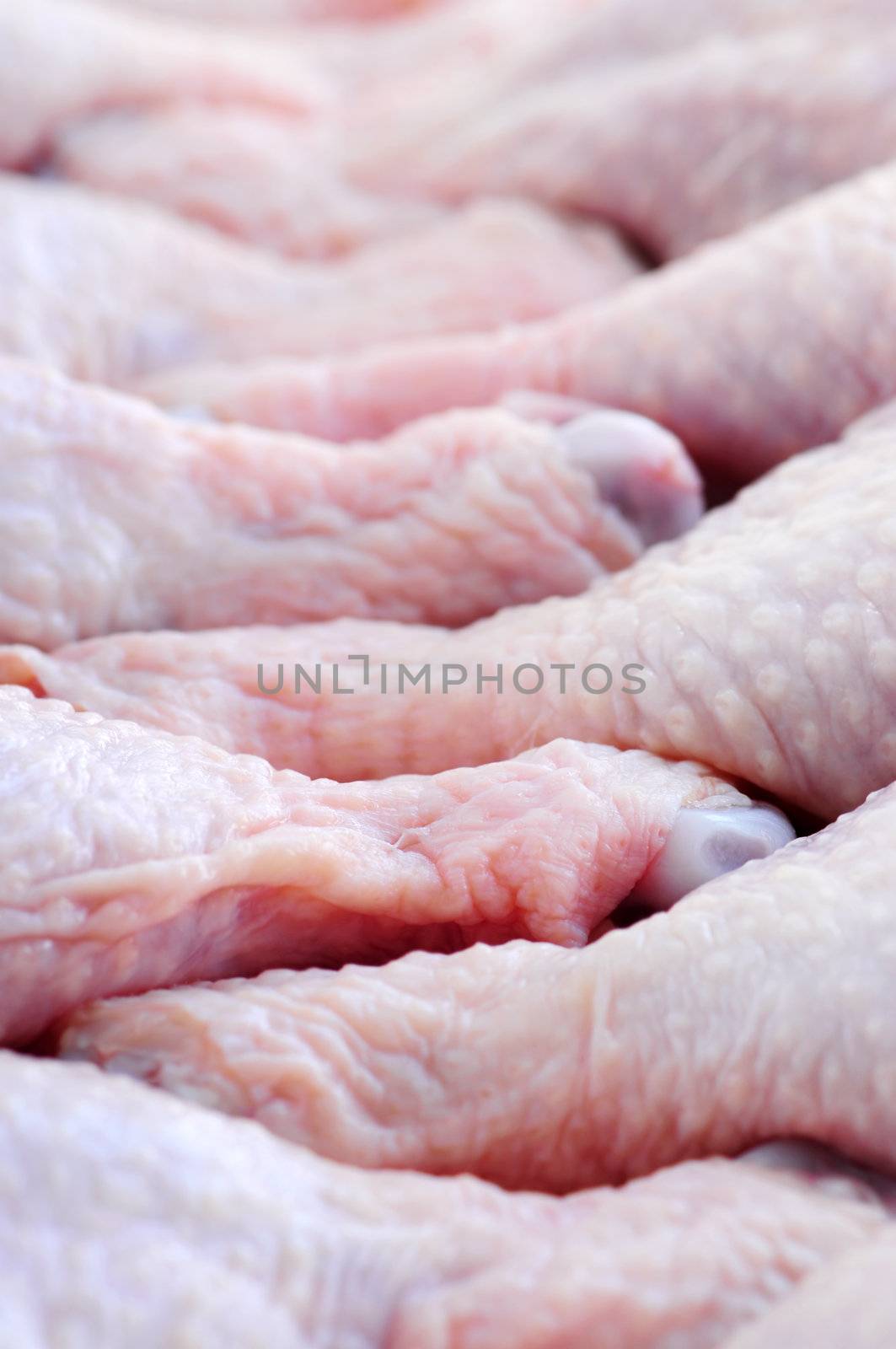 Raw chicken drumsticks in a supermarket package