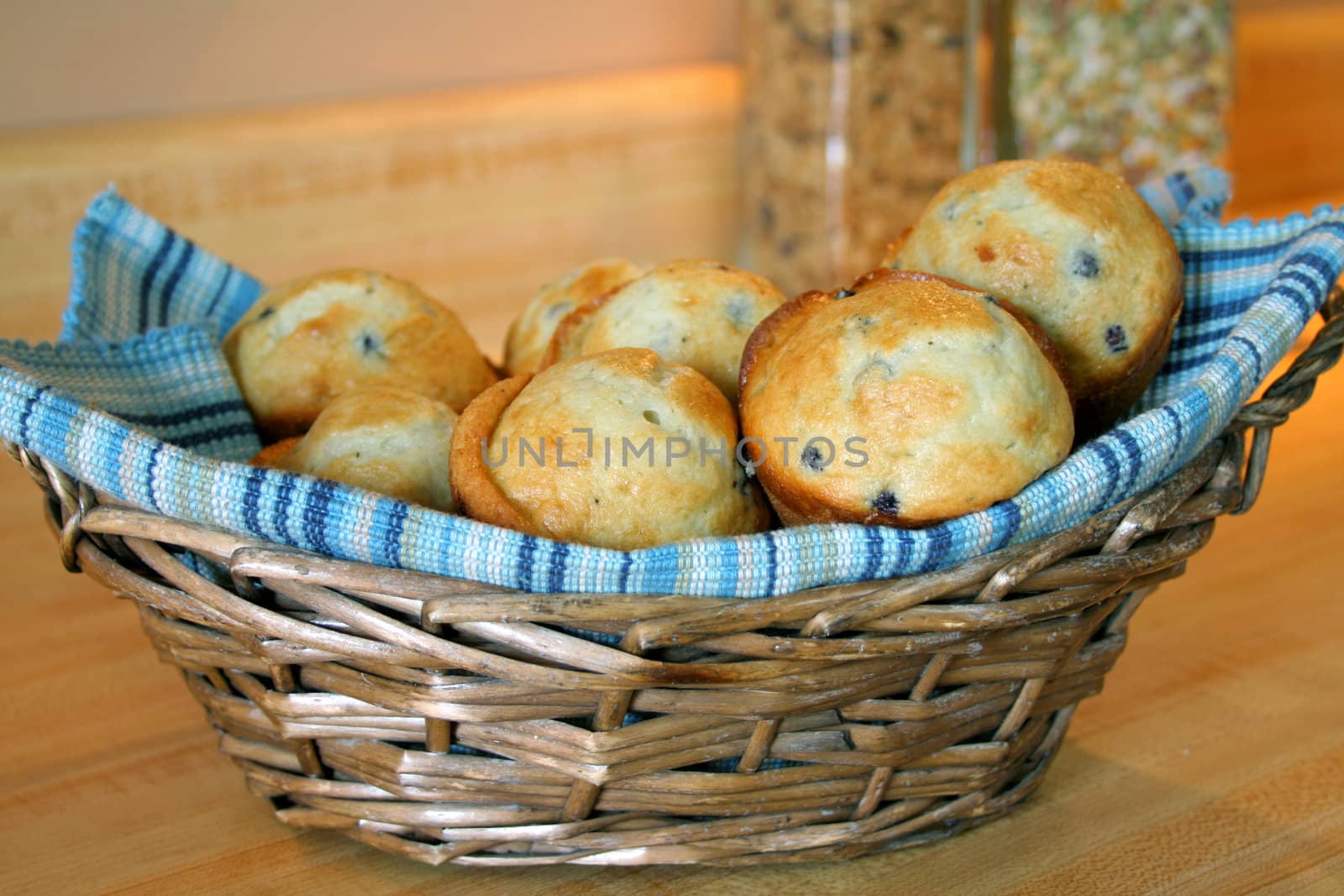 A basket full of blueberry muffins.