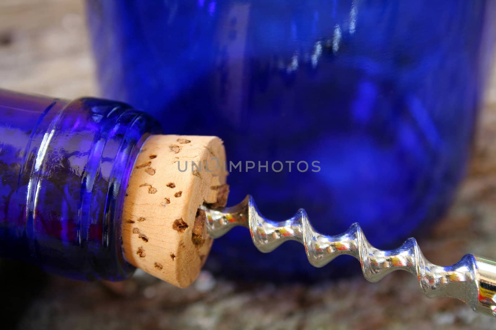 Close up of a wine cork and corkscrew.