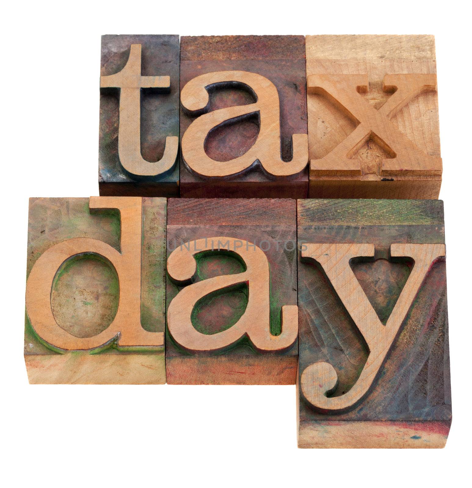 tax day - words in vintage wooden letterpress printing blocks, stained by color inks, isolated on white