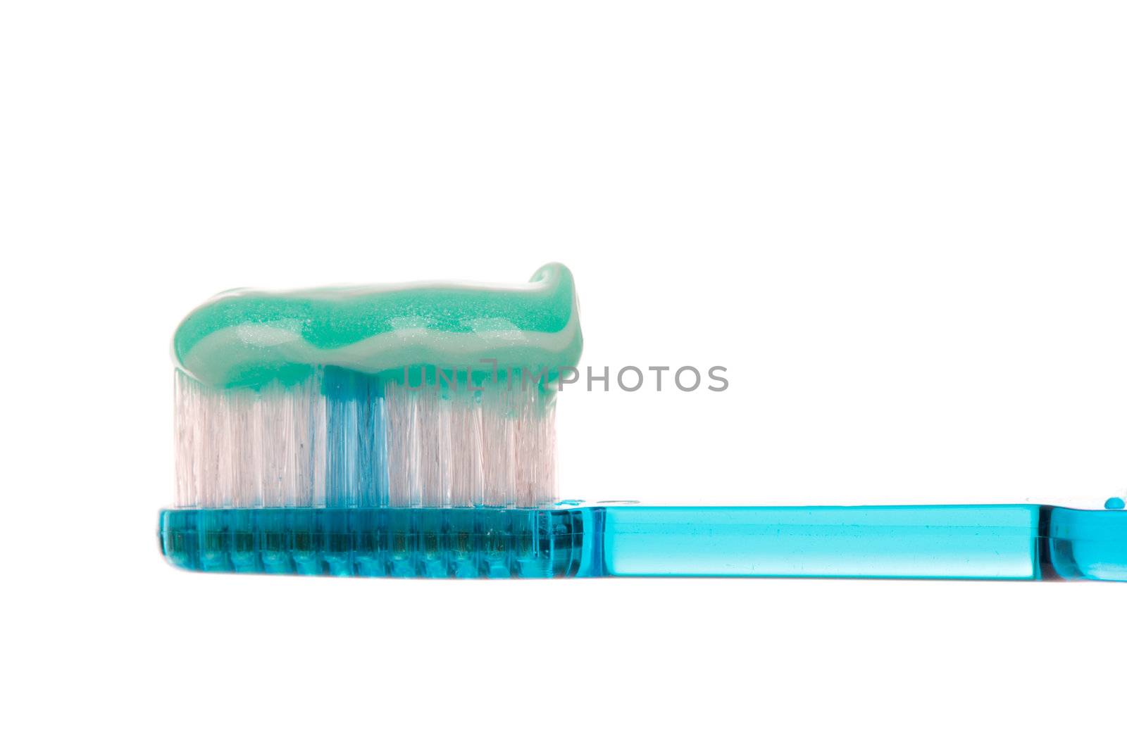 Semi transparent blue toothbrush with a sparkly mint stripe toothpaste.  White background.