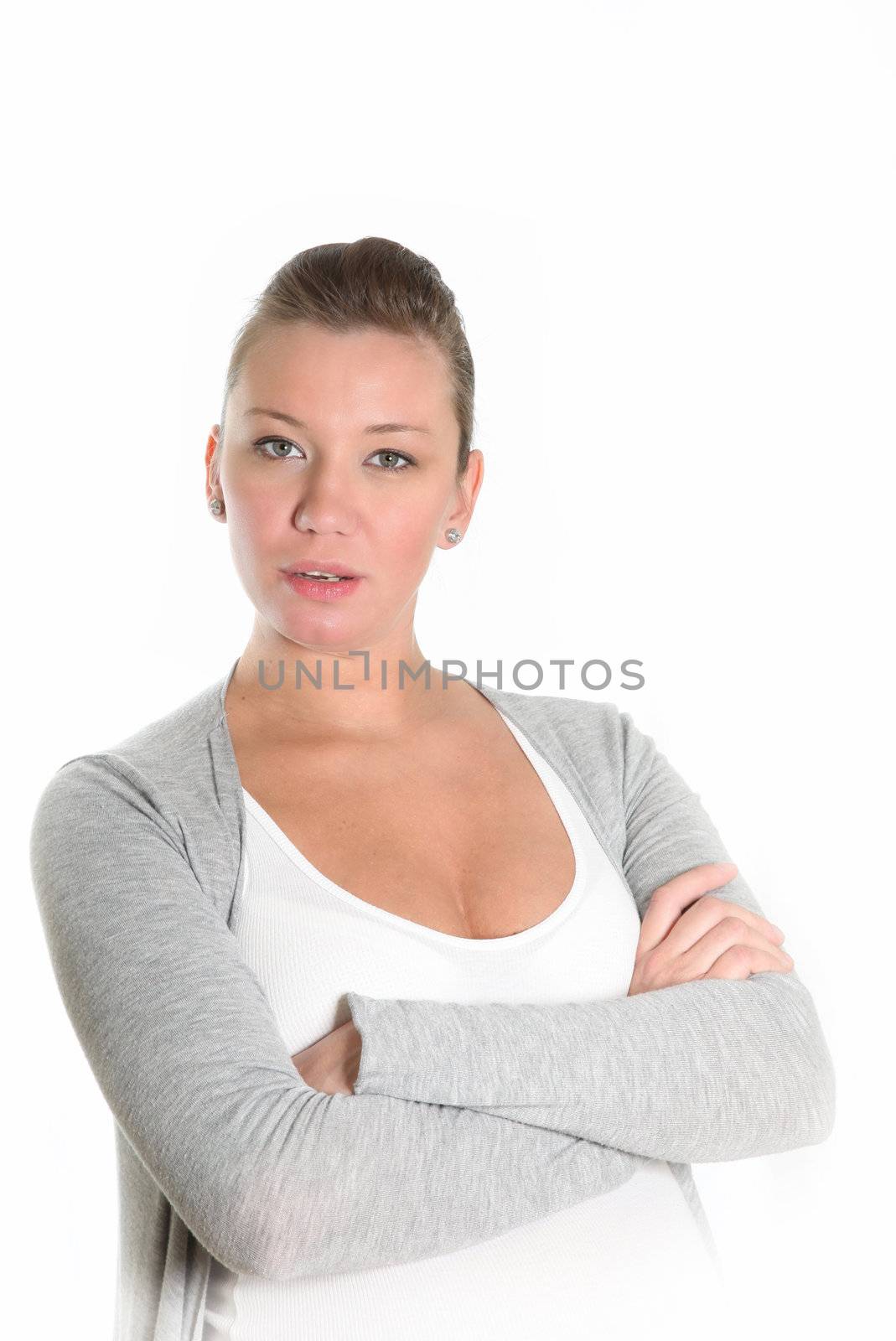 portrait of a surprised and questioning woman with arms crossed in front of white background.
 