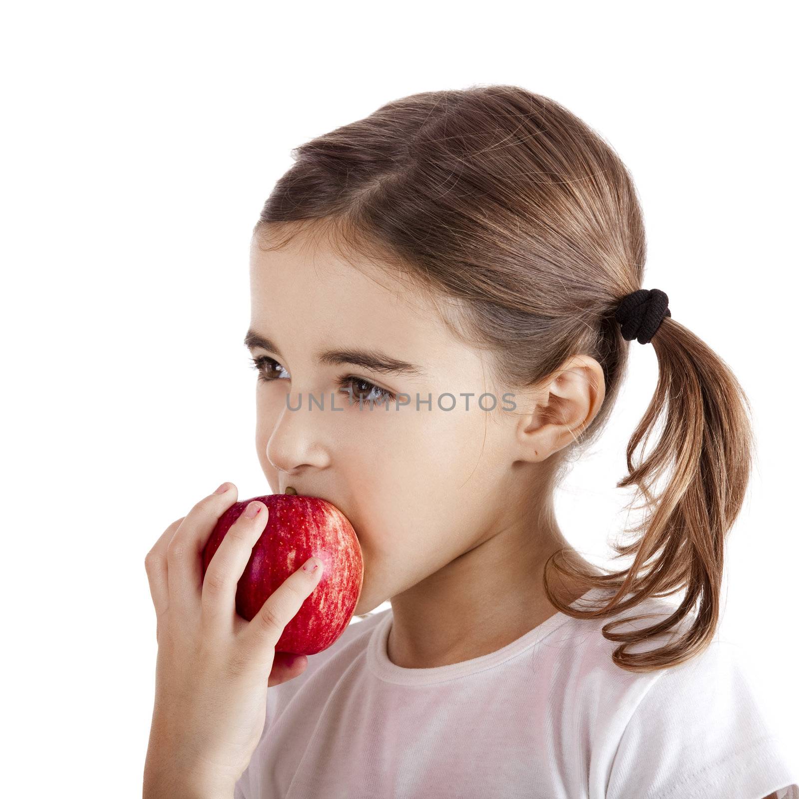 Portrait of a beautiful little girl eating a red apple